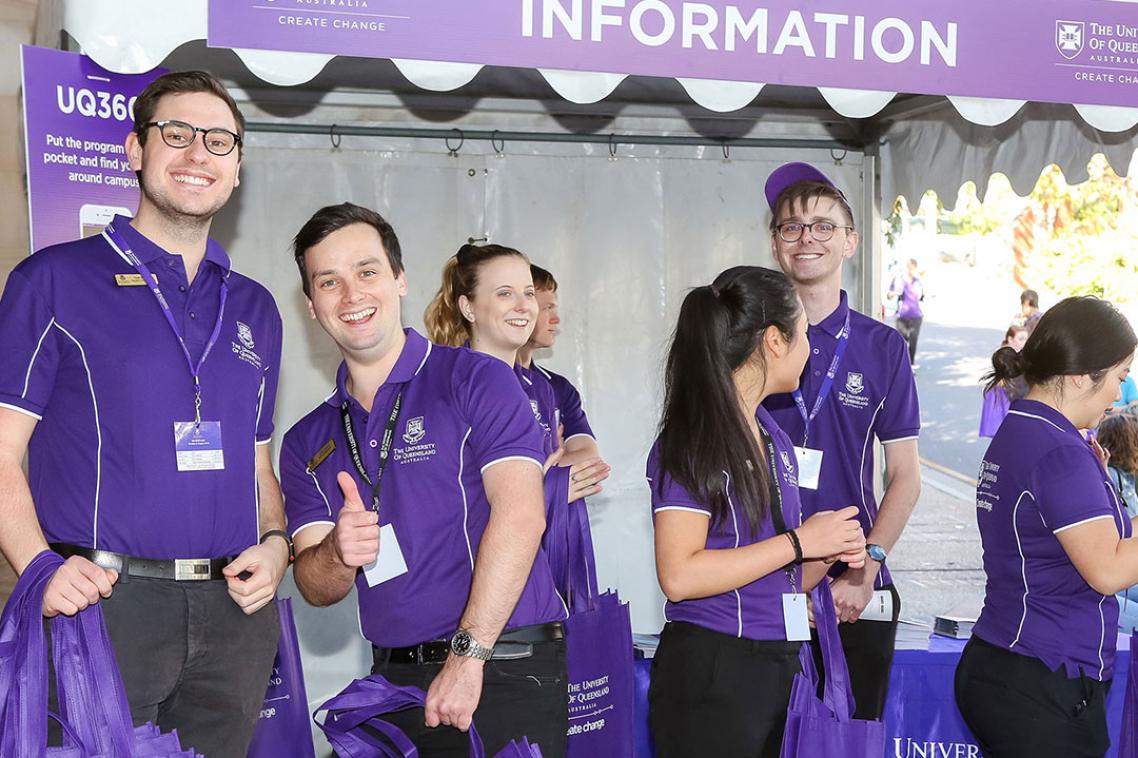 Student ambassadors hand out tote bags at Open Day.